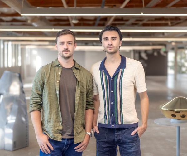 Two men from Inversion Space standing in their workspace