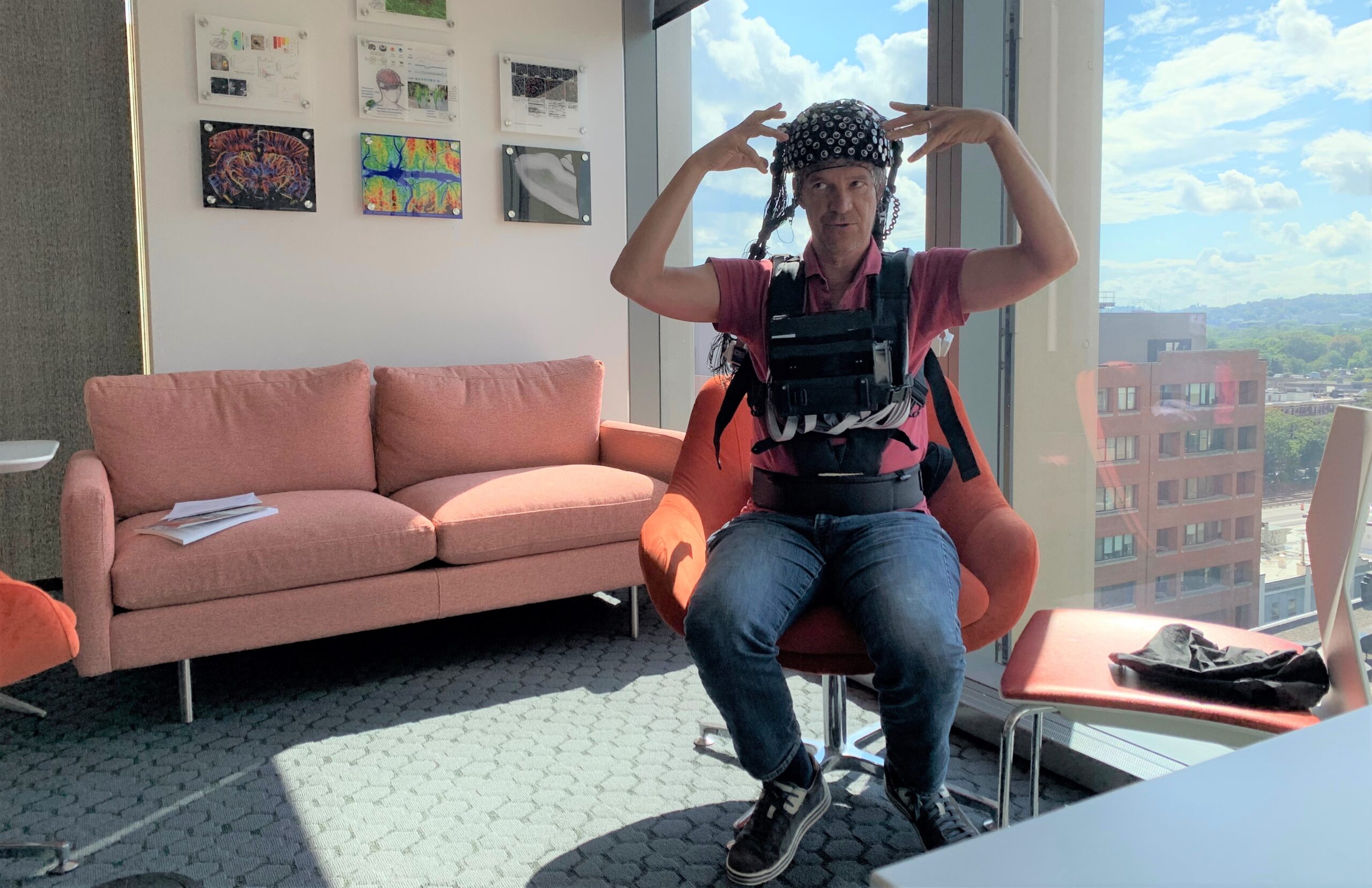 man seated in office wearing experimental headgear
