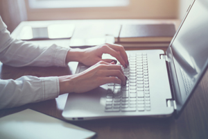 Woman working at a laptop.