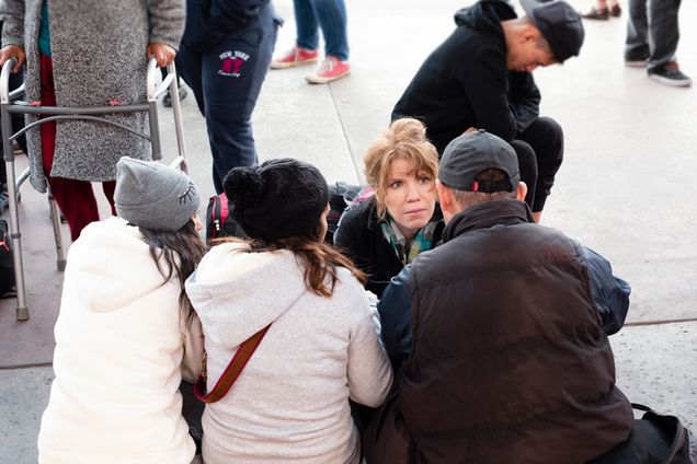 Karen Pita Loor, a School of Law clinical associate professor of law, talks to Central American migrants in Tijuana, Mexico, about the US asylum process, during a recent trip by LAW faculty and students to the border