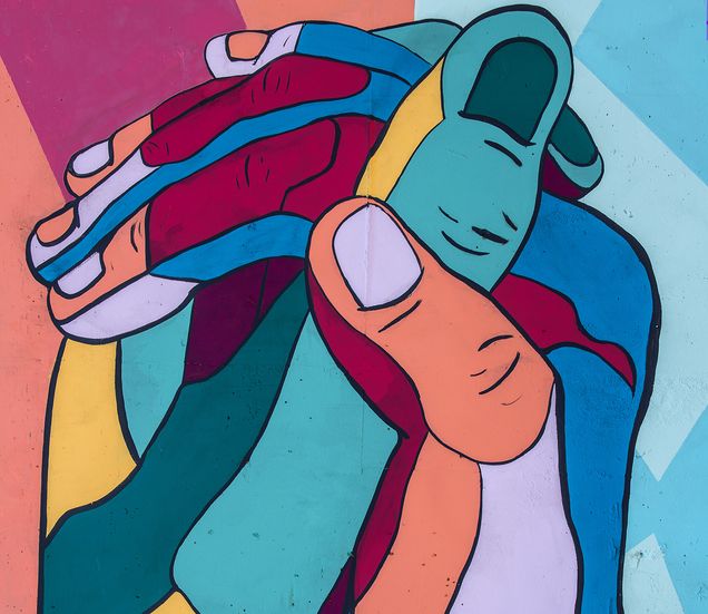 Two clasped hands illustrated in different colors