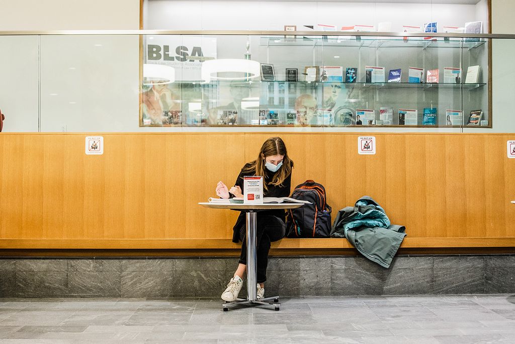 A student studies near McCausland Commons