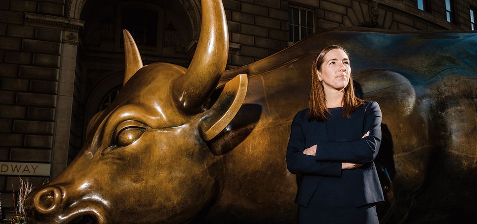 Jennifer O'Neil ('07) stands before the Charging Bull statue on Wall Street in New York City