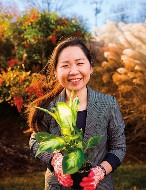 Sansanee Dhanasarnsombat (LLM'05) holding a potted plant