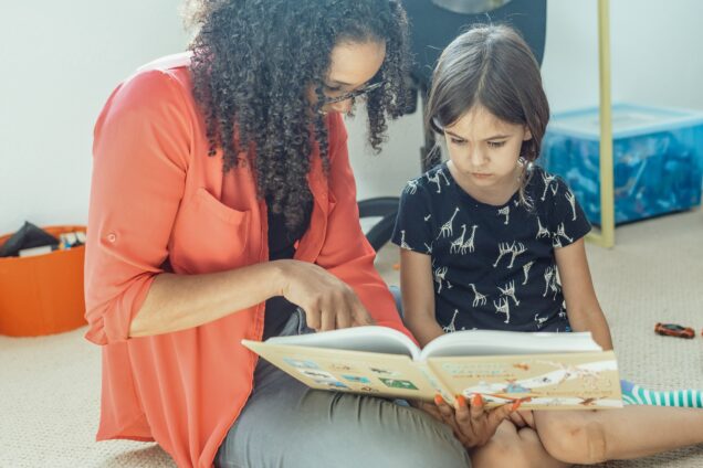 Woman reads to young girl