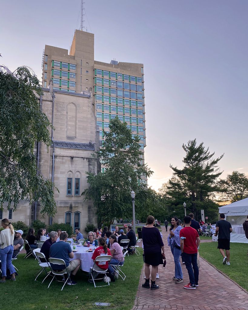 2L students at a BBQ with the law tower in the background