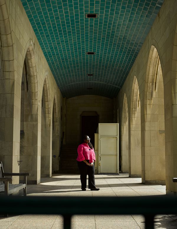 Dean Angela Onwuachi-Willig stands under stone archway in BU's Marsh Plaza