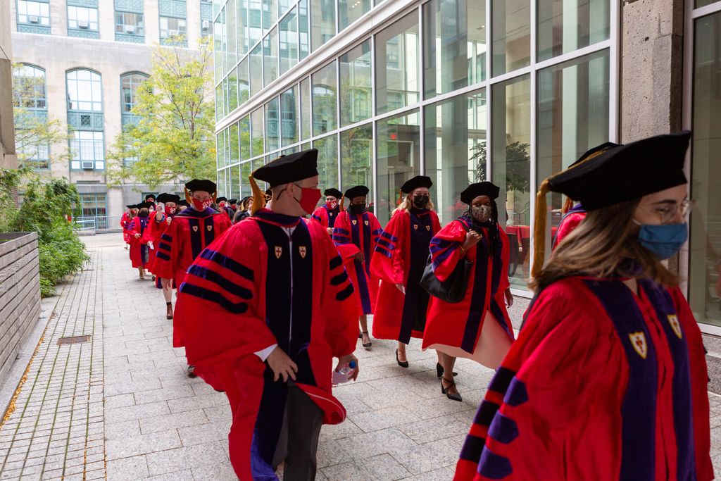 BU Law graduates wearing regalia lined up for commencement.