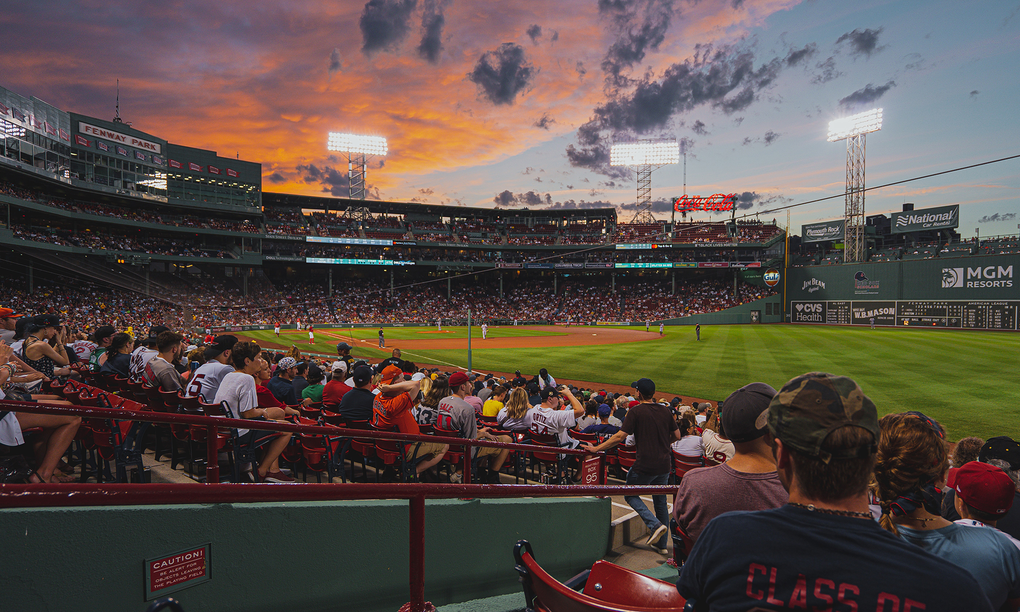 Fans watch a baseball game at Fenway Park in Boston, MA