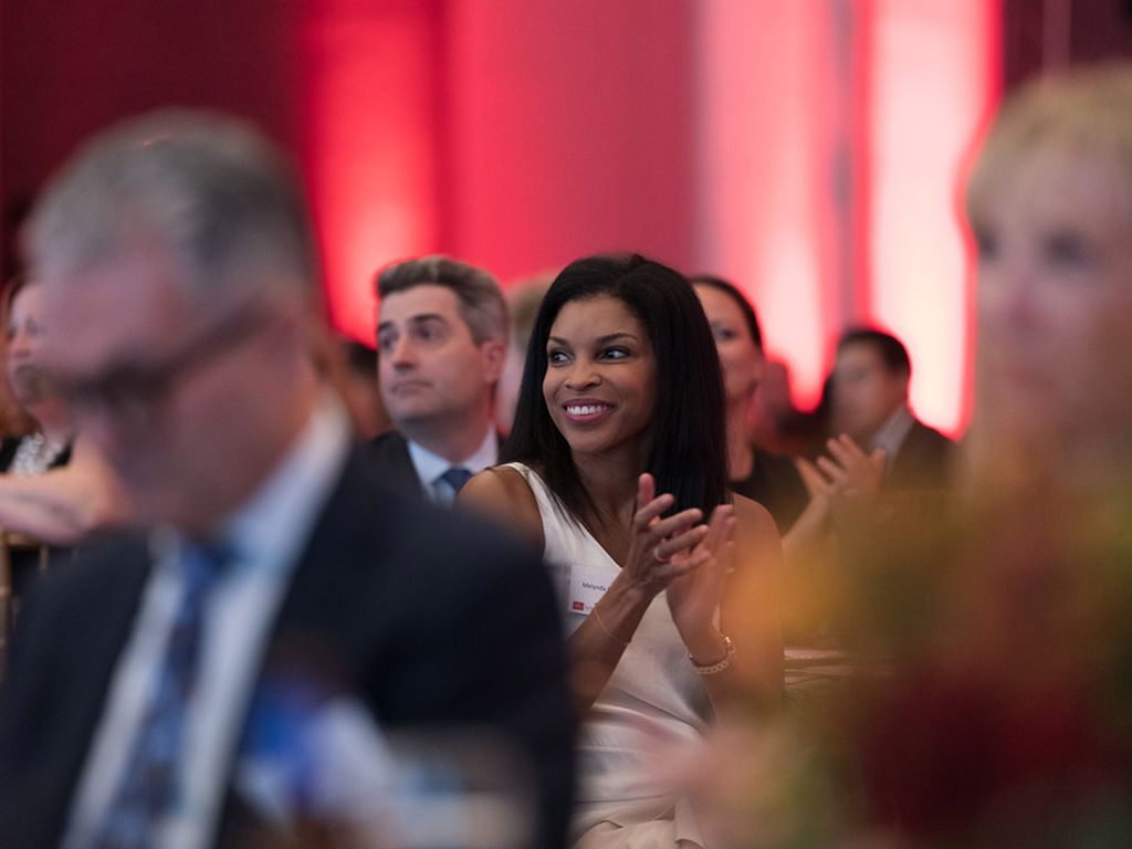 A woman claps during the speeches at the BU Law 150th anniversary gala