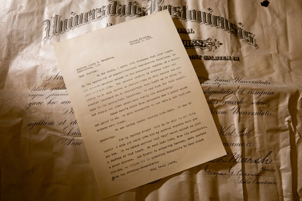 A letter to Hon. Louis Brandeis of the US Supreme Court sits on top of an 1890 BU Law diploma