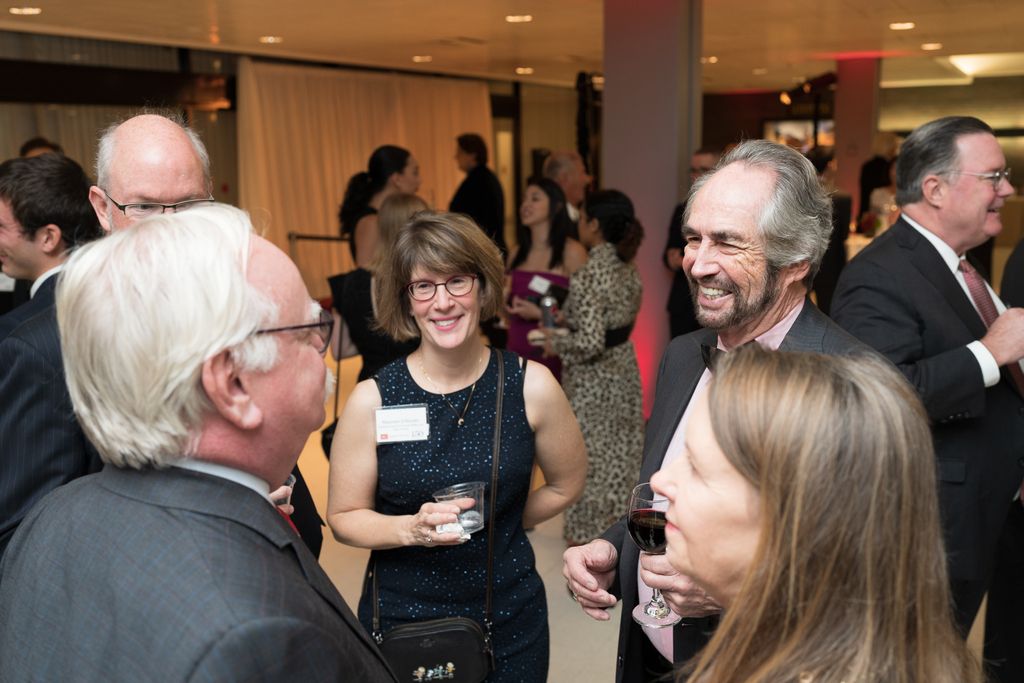 BU President Robert A. Brown speaking with Gala guests including Gerard Cohen ('62).