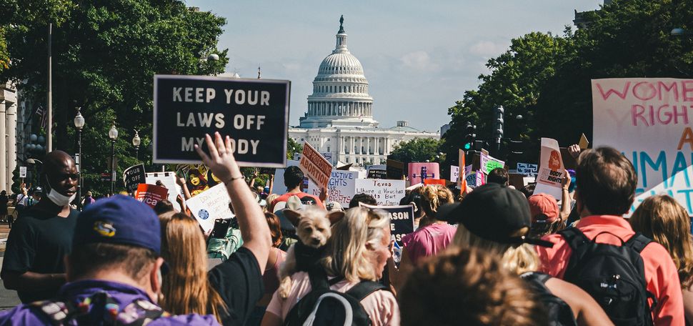 A large group of reproductive rights protestors approach the US Capitol building