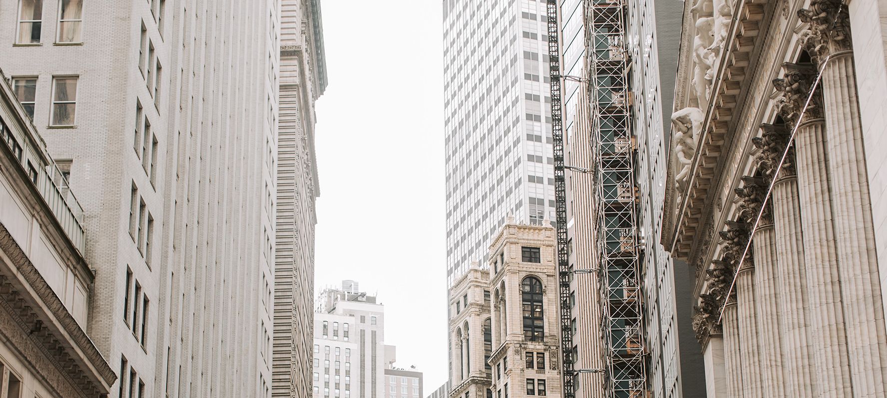 The buildings of Wall Street viewed from the ground.