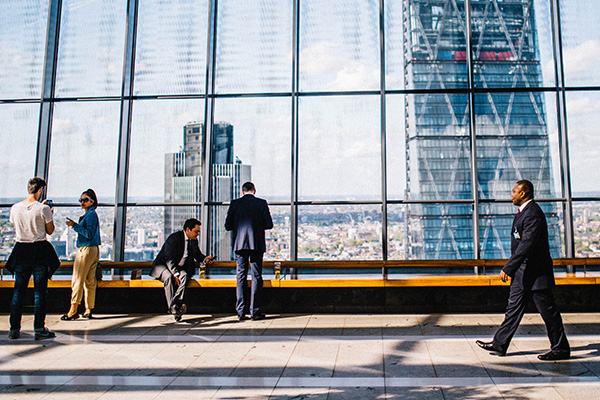 Corporate, business, and transactional law at BU Law. Corporate workers sitting and walking at tall office building.