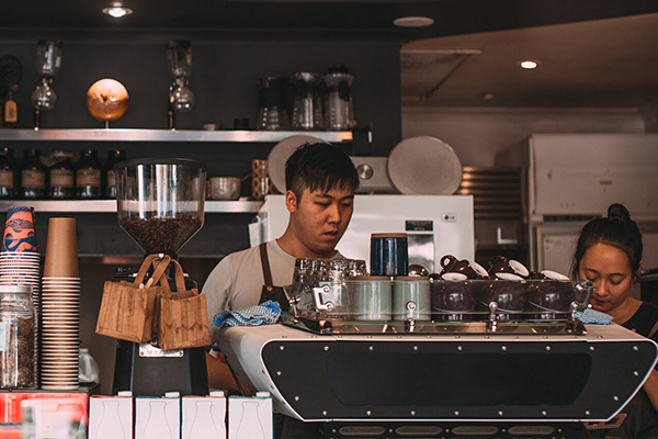 Employment and labor law at BU Law. Two baristas working at a coffee shop.