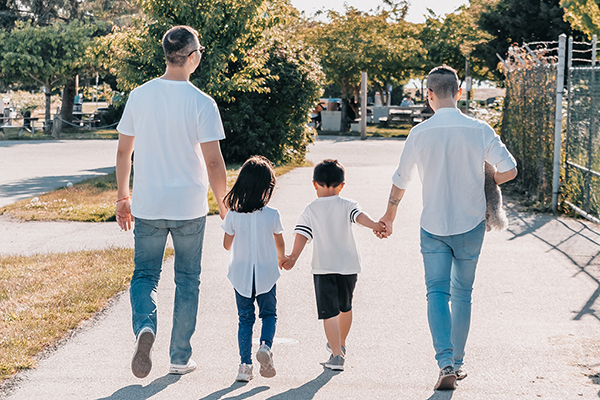 Family, law, gender and sexuality at BU Law. Family with two children walking down street.