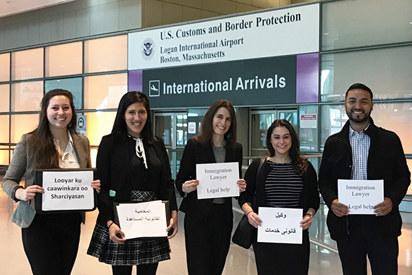 Race, racism, and the law at BU Law. Immigration lawyers standing in front of Logan International Airport Customs and Border Protection.