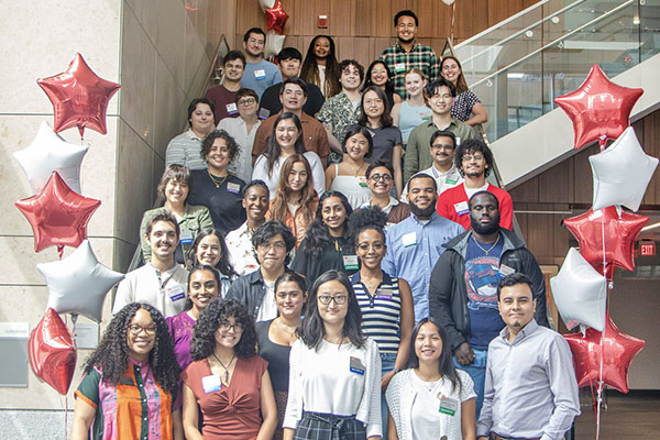 A large group of students poses for a photo at Be Yourself Orientation.