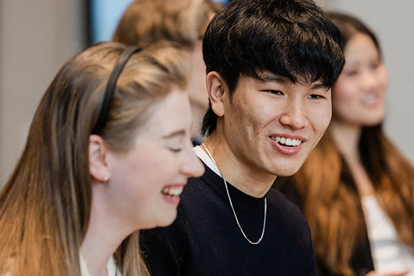 Two JD students talk and laugh.