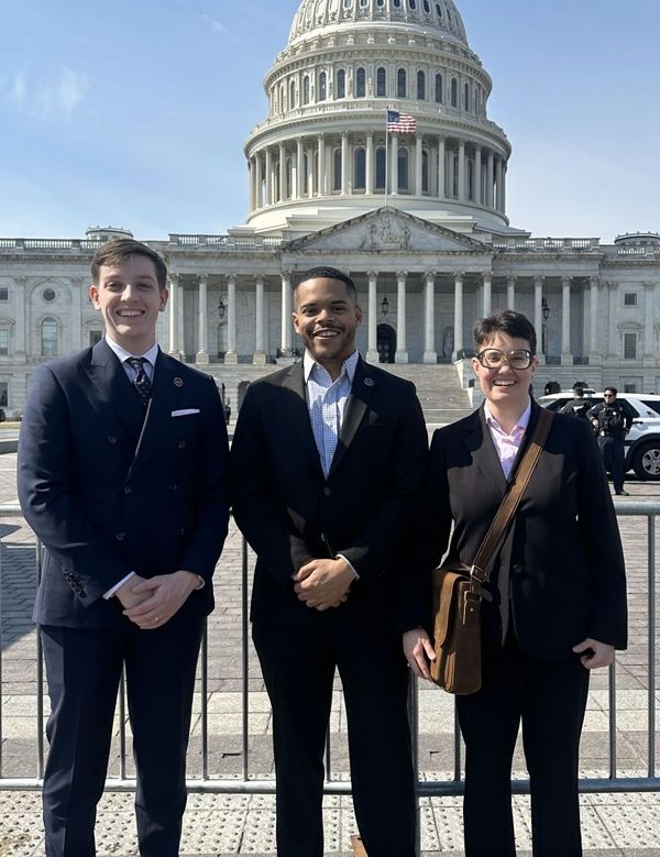 Photo of Nicholas Wainwright, Tyler Roderick, and Sofia Steinberger standing in front of the Capitol Building.