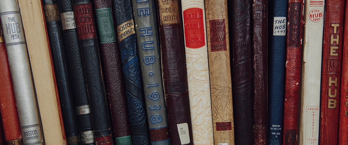 book spines of BU Hub publication arranged on a shelf