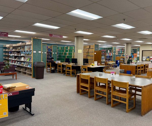 The Science & Engineering Library's open study seating with students and shelves.