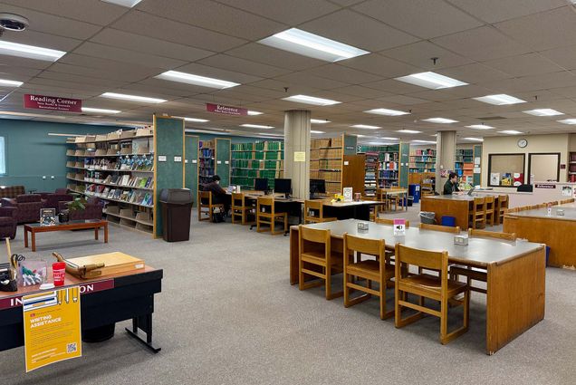 The Science & Engineering Library's open study seating with students and shelves.