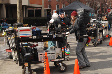 2 crew with camera equipment carts out on the street