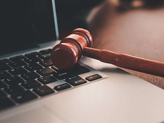 A gavel set on top of a laptop keyboard