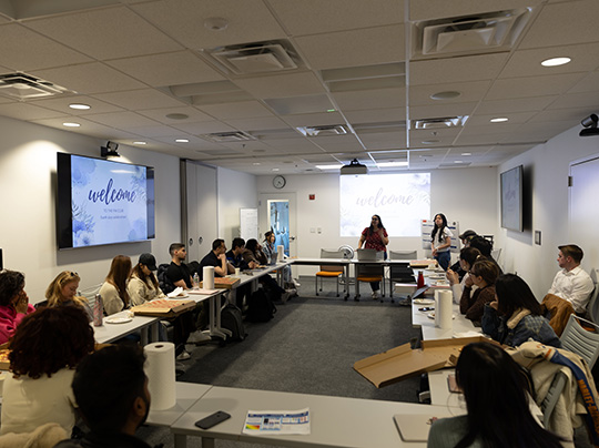 Students presenting at the Boston University Project Management Club Earth Day celebration