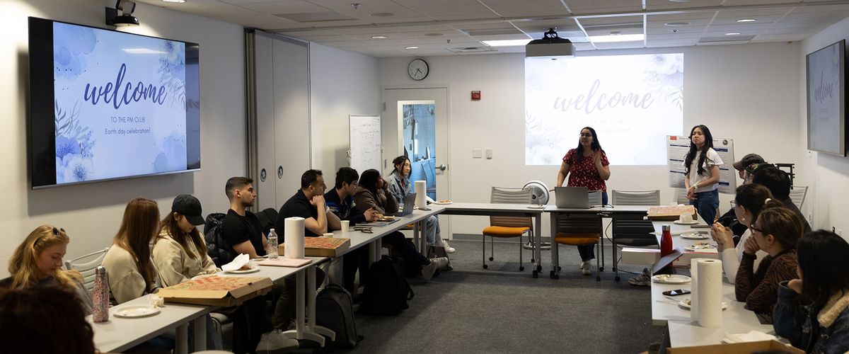 Students presenting at the Boston University Project Management Club Earth Day celebration