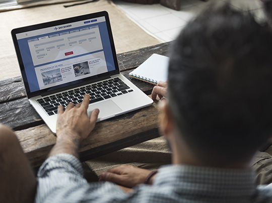 A student filling out a form on a laptop computer