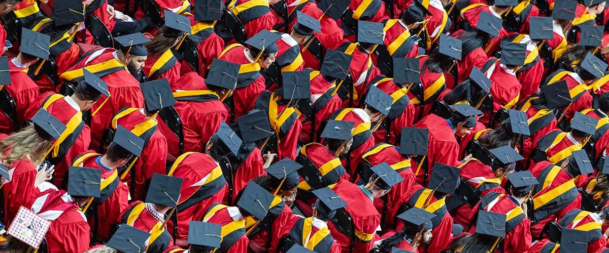 An overhead photo of several MET graduates seated for commencement