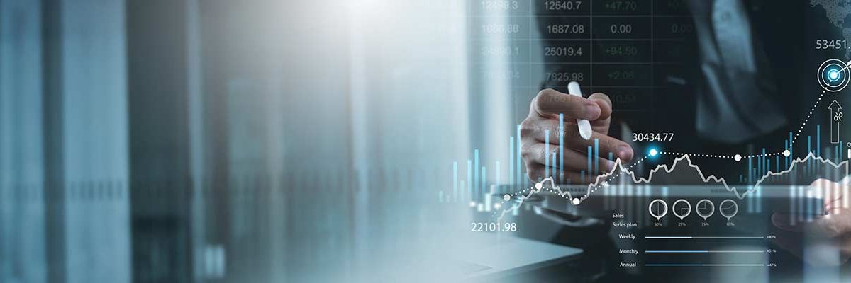 A pair of hands working in the reflection of some digital graphics