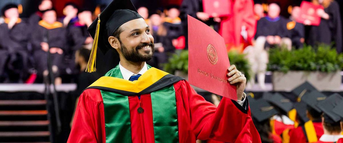 A graduate showing off his diploma during the 2025 MET Convocation ceremony