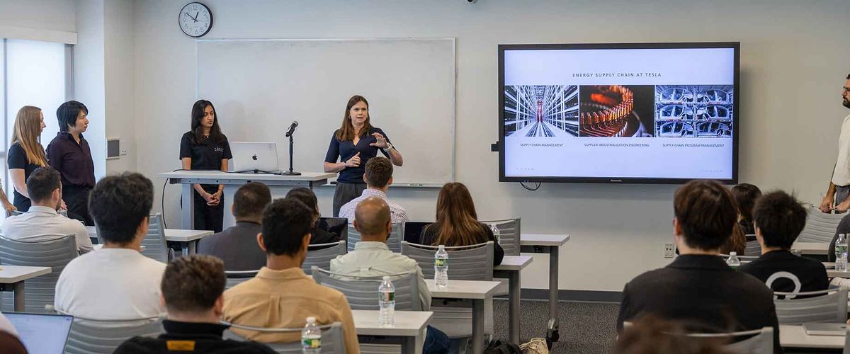 BU alum Laura McIntosh delivers a presentation in a classroom full of students