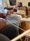 Closeup of people playing drums