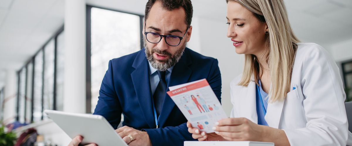 Man in suit and woman in white lab coat