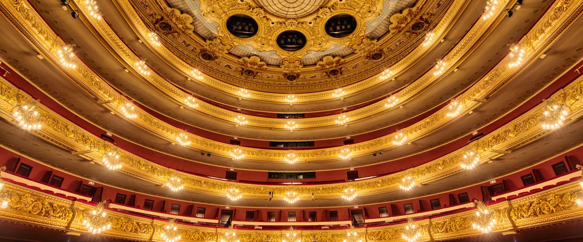 theater interior; circular, golden, with five golden balcony levels and red velvet seats below