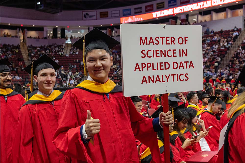 Students at Metropolitan College Commencement lining up to graduate