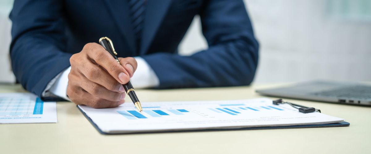 Closeup of a man in a analyzing financial data at a desk