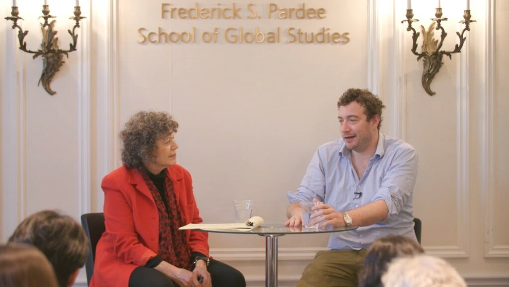Professor Vivien Schmidt and journalist/podcaster Nicky Woolf speak in front of a crowd at the Frederick S. Pardee School. 