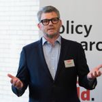 Kevin Gallagher stands in front of a GDP Center banner as he delivers opening remarks at a lecture hosted by the Center.