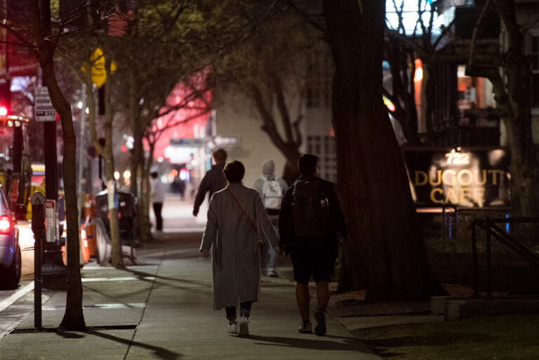 Two students walking on Commonwealth Avenue at night