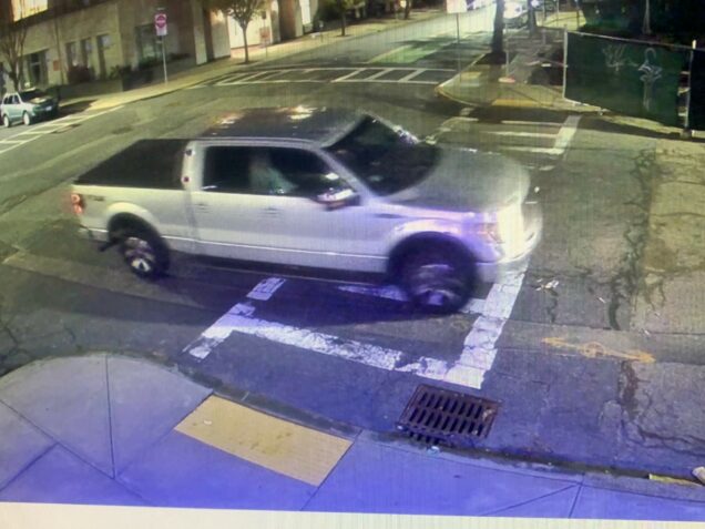 Gray pick up truck driving through cross walk