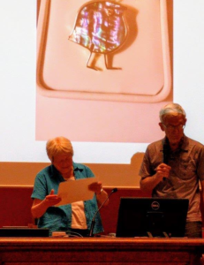 PBS Prof. Emerita Jean Berko Gleason receives the Roger Brown Award at the 14th International Congress of the International Association for the Study of Child Language in Lyon, France. Presented by Brian MacWhinney. Background image is a Wug. In order to perform Prof. Berko Gleason’s famous 'Wug Test’ one requires two of them!