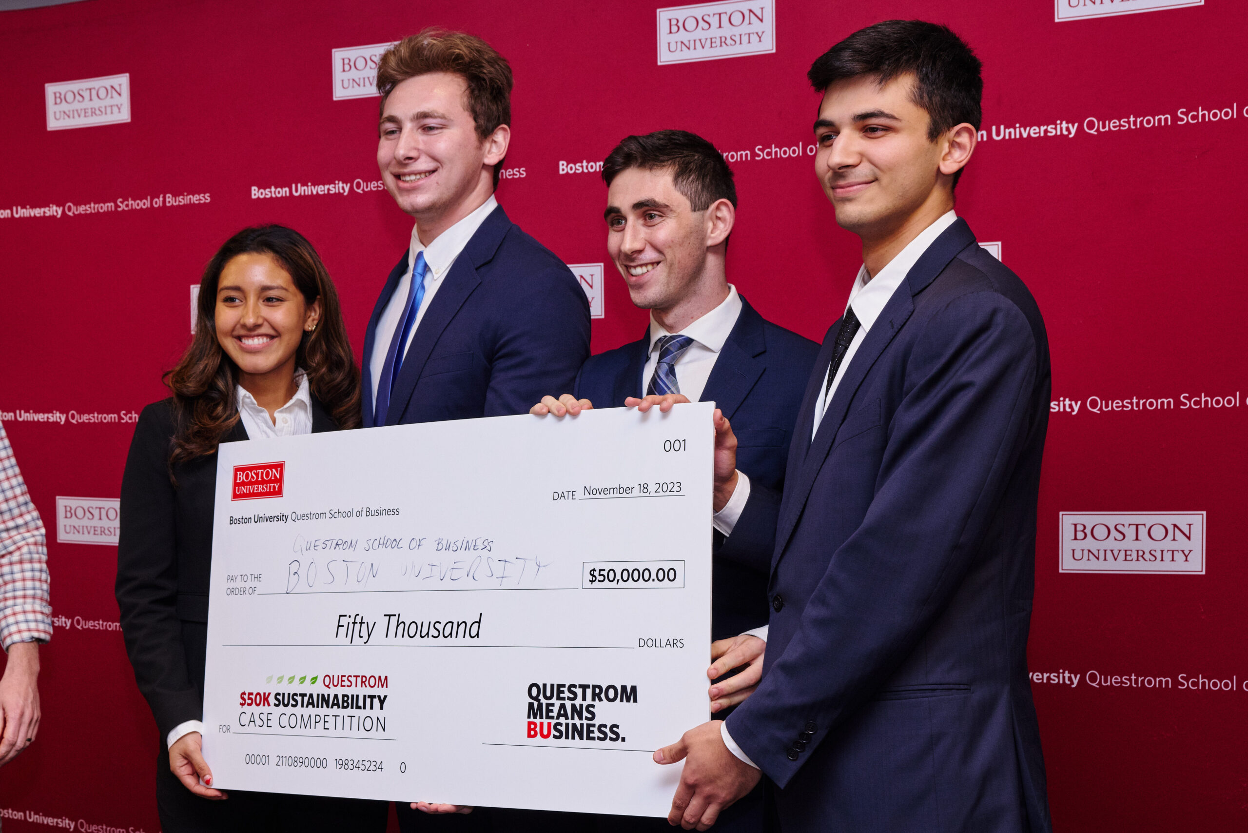 Students holding large check