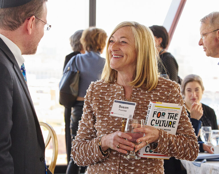 Dean Fournier having a conversation with people at an event