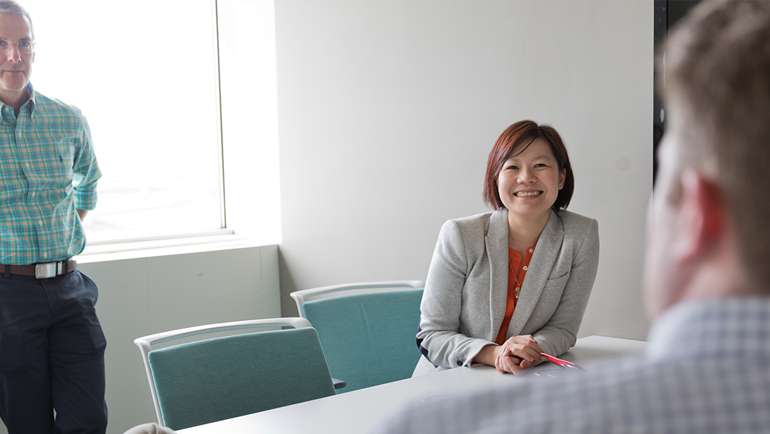 Executive at conference table smiling at camera